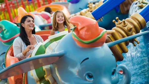 Mom and daughter riding Dumbo at Magic Kingdom at Walt Disney World.