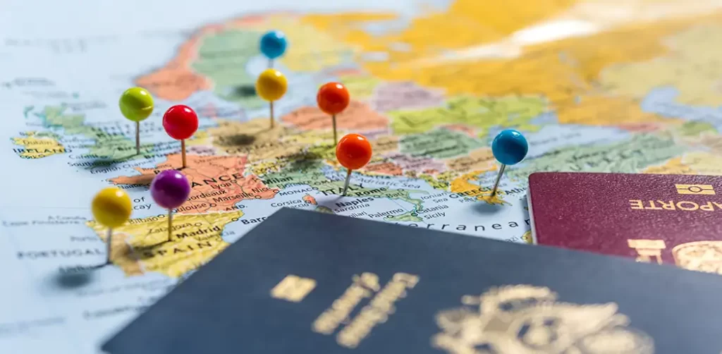 Map of Europe with pins of places to go and see. Two passports are on the map.