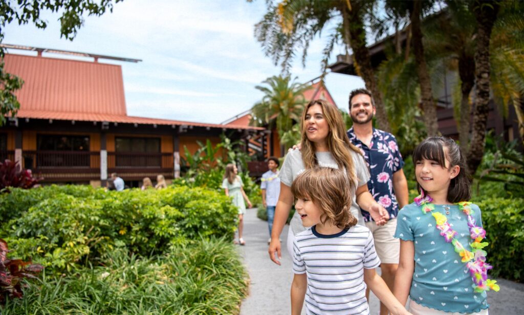 Family of four walking a garden path at Disney Polynesian Village Resort