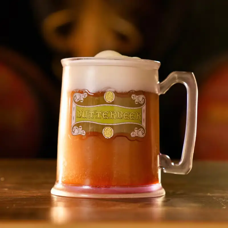 a Frosty Mug Filled with Foamy Butterbeer Sits on a Wooden Surface, Its Vintage-style Butterbeer Label Making It Look Ready for Dining at the Ministry of Magic. - Favorite Grampy Travels - Favorite Grampy Travels 2026