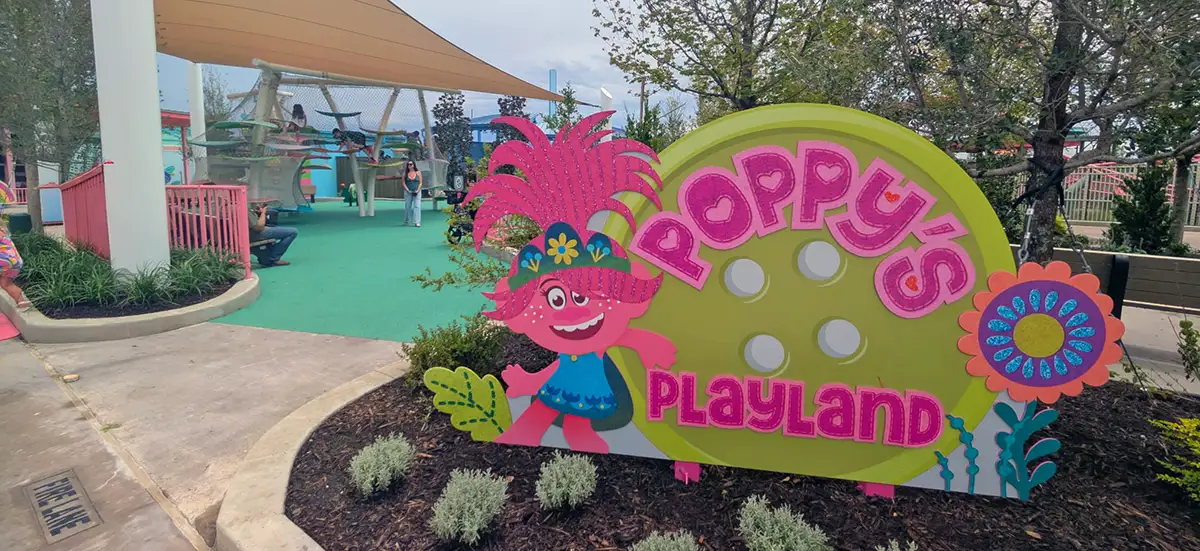 Universal Kids Resort Trolls Poppys Playland - Favorite Grampy Travels Poppy - Favorite Grampy Travels 2026's Playland sign at Universal Kids Resort with the Trolls themed climbing and net structure behind it