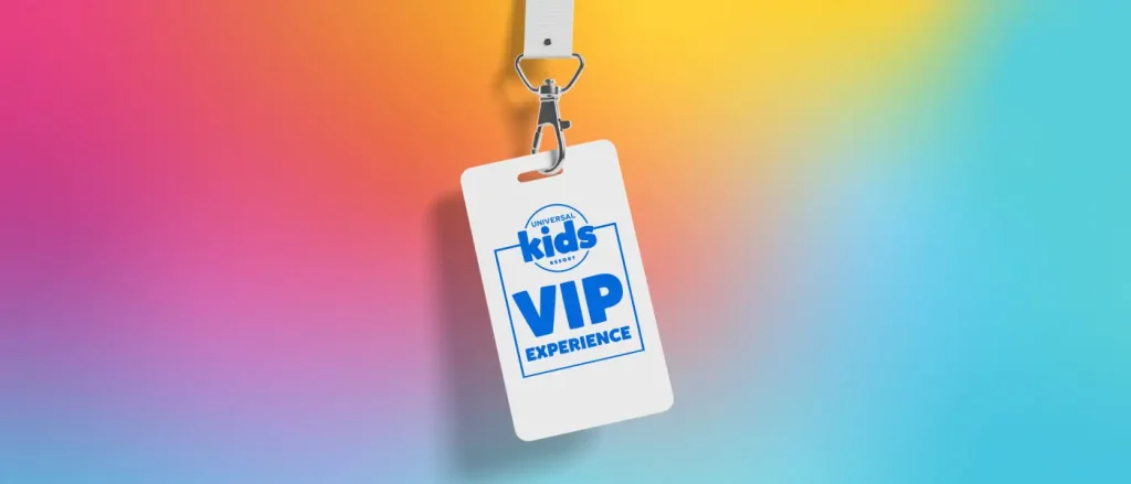 A white lanyard from Universal Kids Resort with a badge reading VIP EXPERIENCE hangs against a colorful gradient background of yellow, pink, and blue. - Favorite Grampy Travels