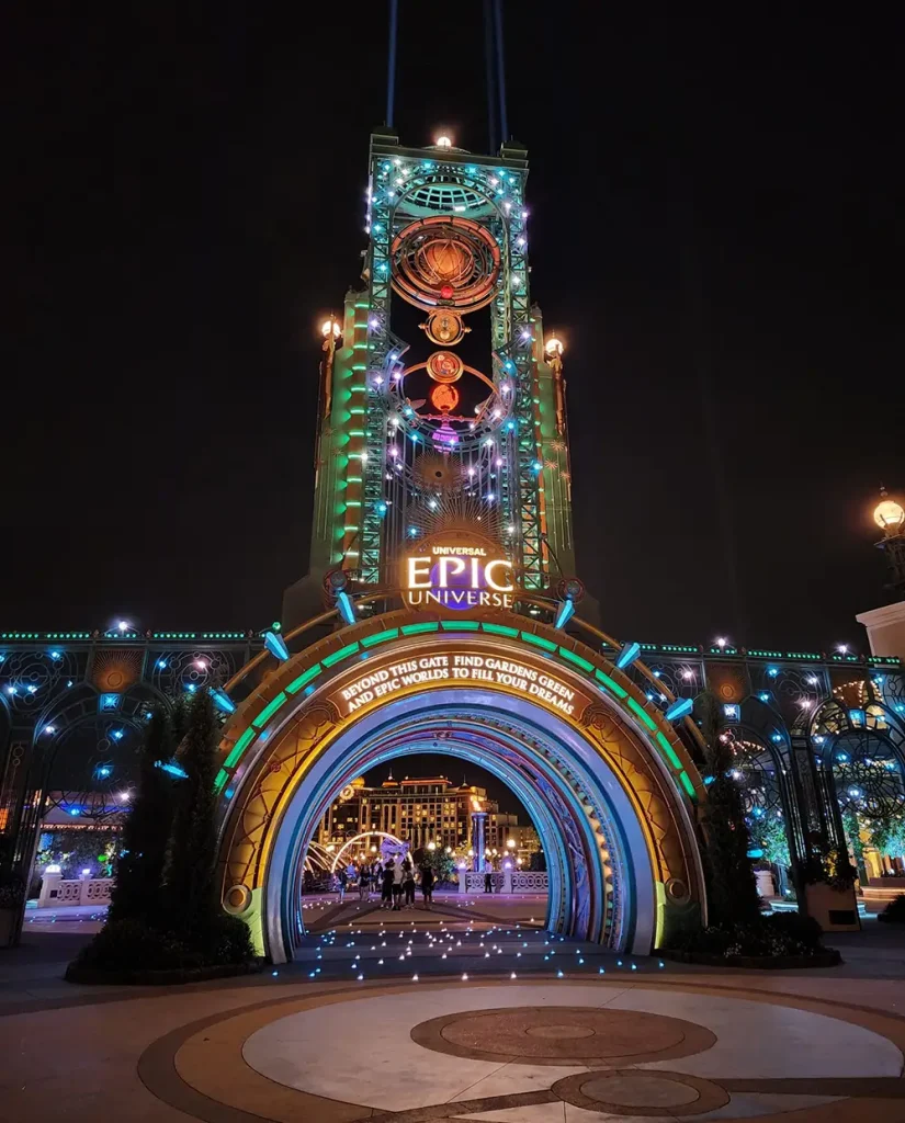 Uor-epic-universe-entrance-portal-night-time - Favorite Grampy Travels a Tall, Illuminated Archway at Night with Vibrant Blue and Orange Lights Welcomes Visitors to Universal Orlando’s Epic Universe, Featuring a Glowing Circular Entrance and Futuristic Decorations—a Perfect Spot to Begin Your Vacation Package Adventure. - Favorite Grampy Travels - Favorite Grampy Travels 2026