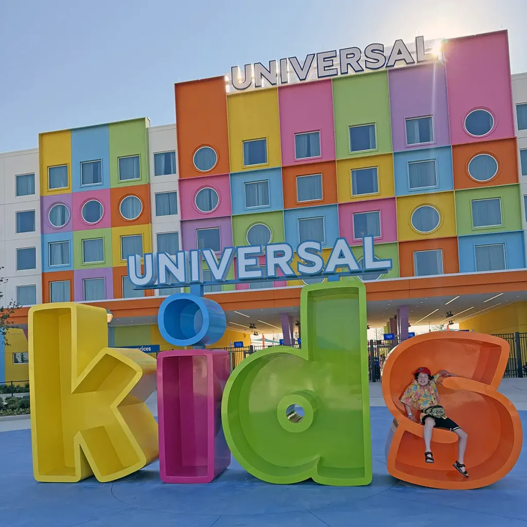 Universal Kids Resort Hotel is a Colorful Hotel with Large Universal Kids Letters in Front. a Child Sits Playfully Inside the Letter D of Kids. - Favorite Grampy Travels - Favorite Grampy Travels 2026