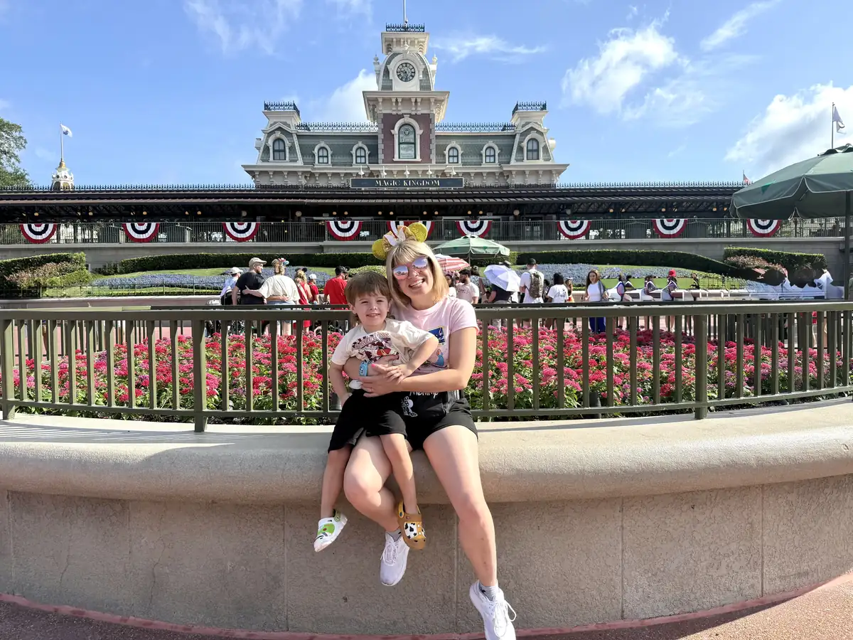 Korrine Ferrari and her son at the Magic Kingdom train station