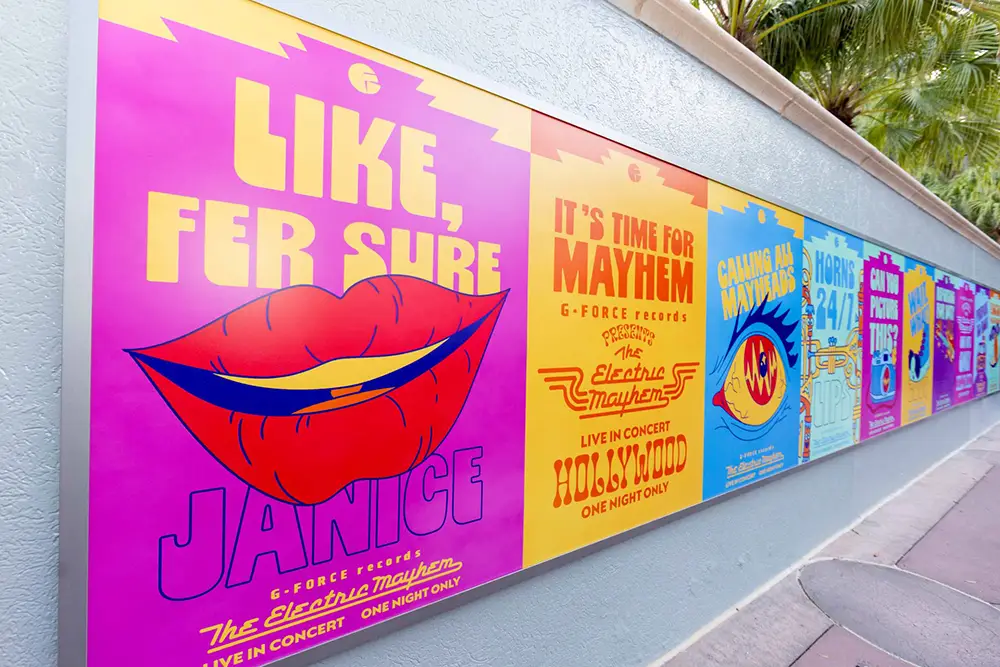 Colorful Posters on a Wall Feature Bold Fonts and Pop Art Graphics, Including Lips and Eyes, Advertising the Electric Mayhem Live Concert with Phrases Like Like, Fer Sure and Its Time for Mayhem.. - Favorite Grampy Travels - Favorite Grampy Travels 2026