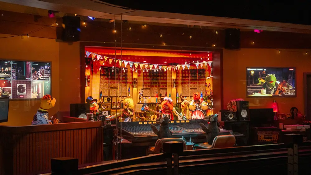 a Recording Studio Scene with Muppet Characters Playing Instruments, Colorful Decorations, and Control Panels, Viewed Through a Glass Window with Monitors on the Wall Showing Related Images. - Favorite Grampy Travels - Favorite Grampy Travels 2026