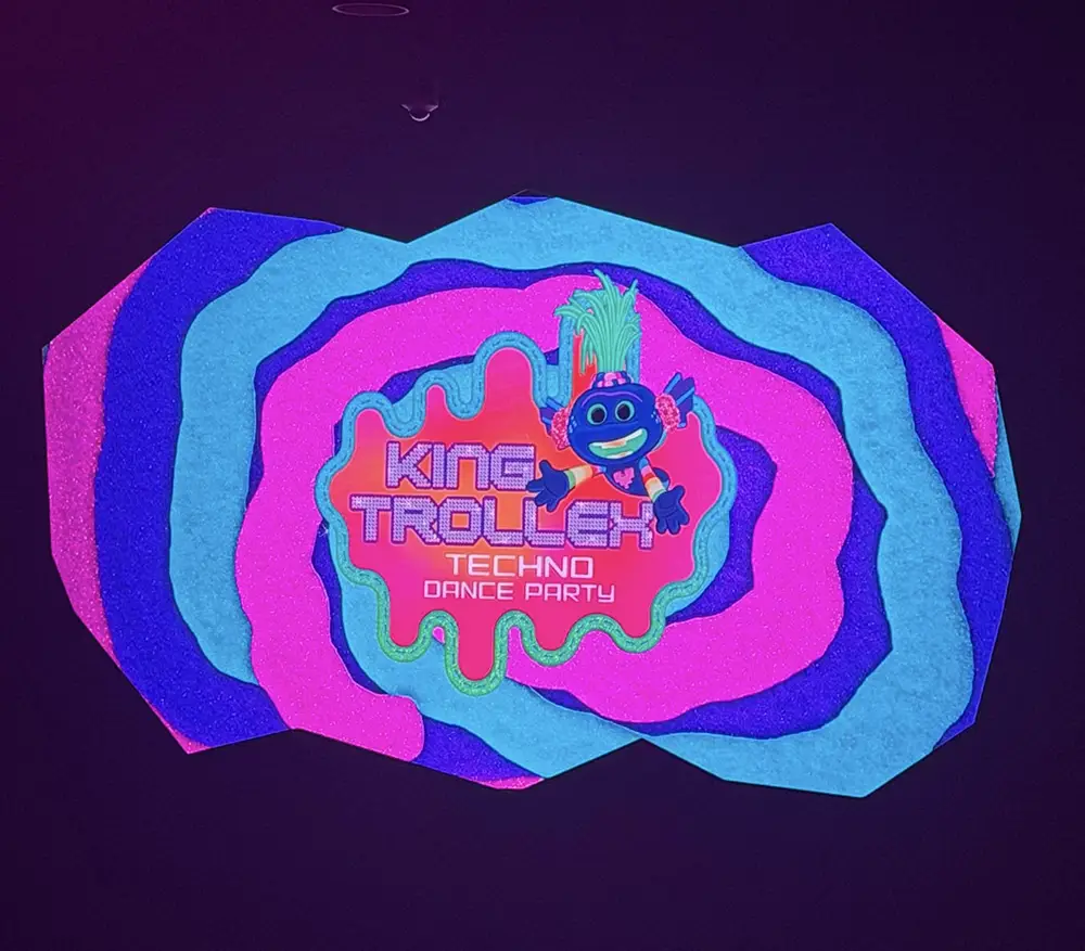 Ukr-trolls-king-trollex-techno-dance-party-sign - Favorite Grampy Travels A colorful, layered, abstract background with text KING TROLLEX TECHNO DANCE PARTY and a smiling blue cartoon character with green hair featured in the center. - Favorite Grampy Travels