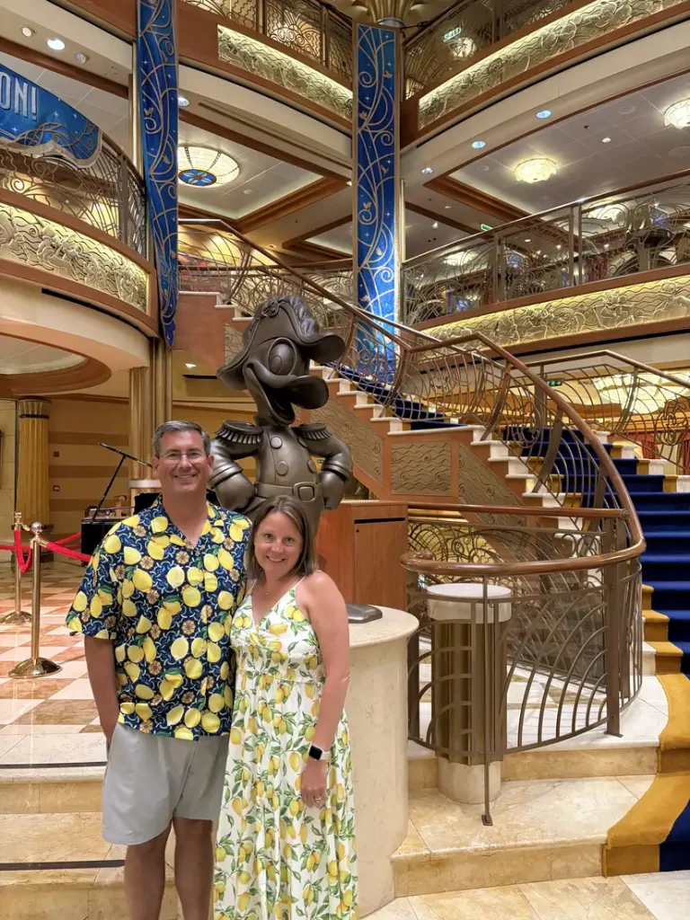 Vicki Kopidlansky and her husband in a Disney cruise ship atrium