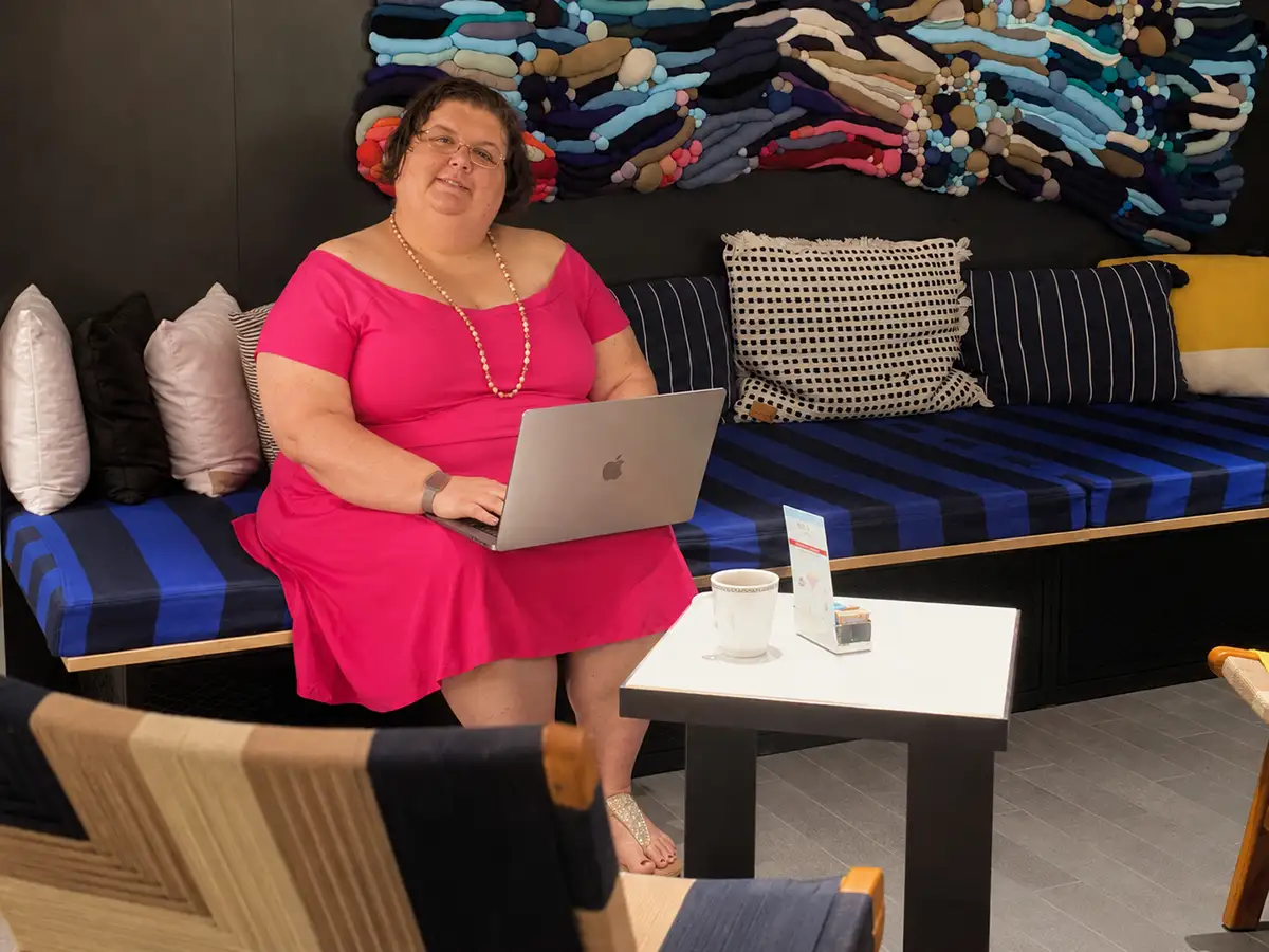 Travel advisor working on a laptop in a resort hotel lobby