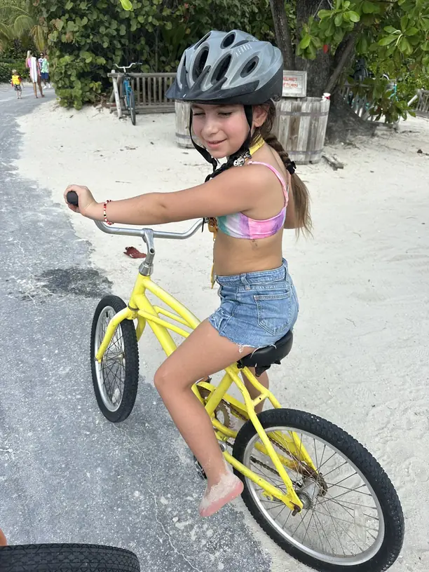 Avilene on a yellow rental bike on Castaway Cay, Disney's private island