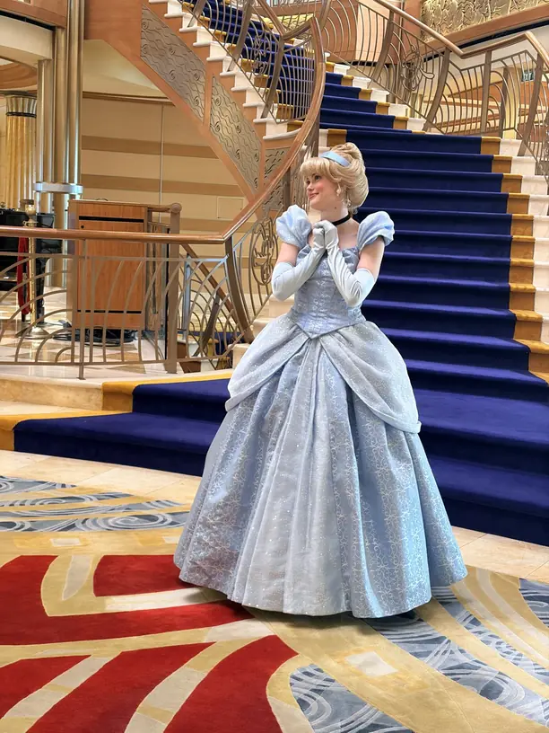 Cinderella on the grand staircase in the atrium of a Disney cruise ship