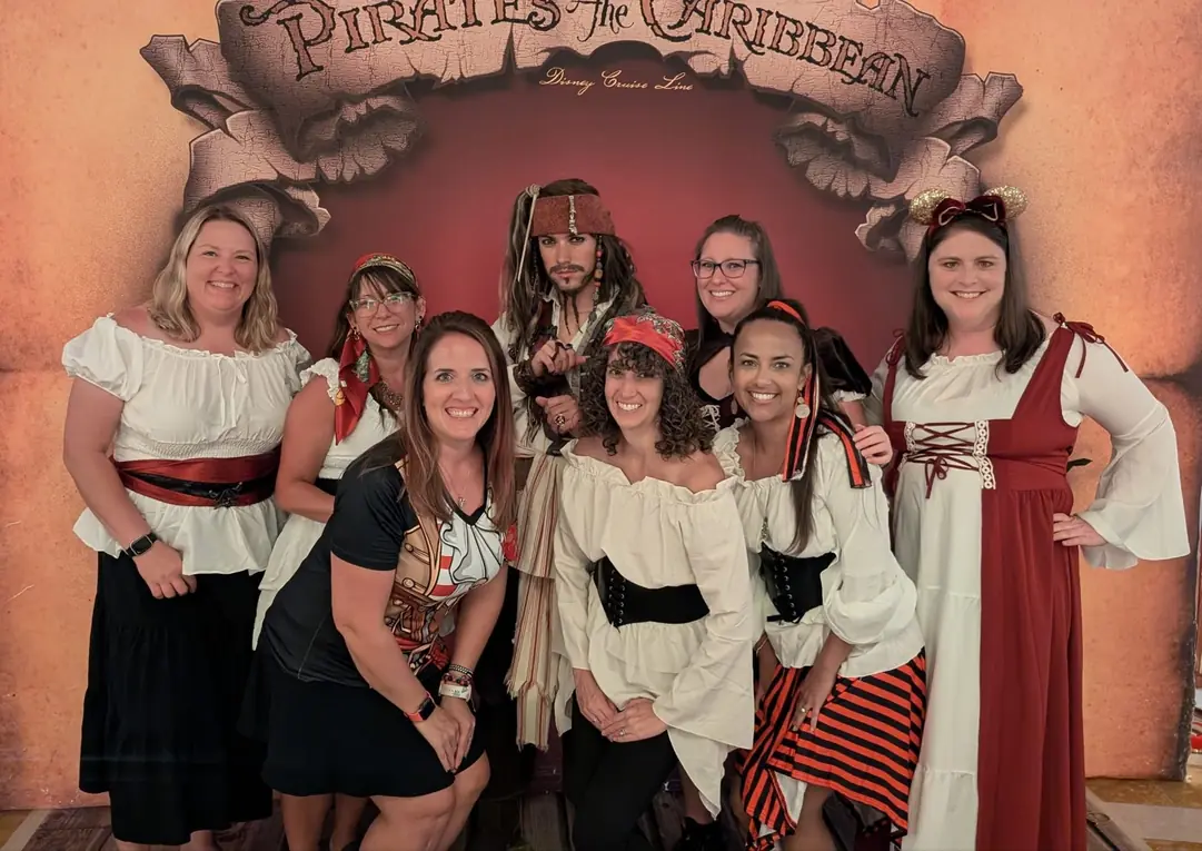 Nicole and friends in pirate costumes with Captain Jack Sparrow on Disney Cruise Line Pirate Night