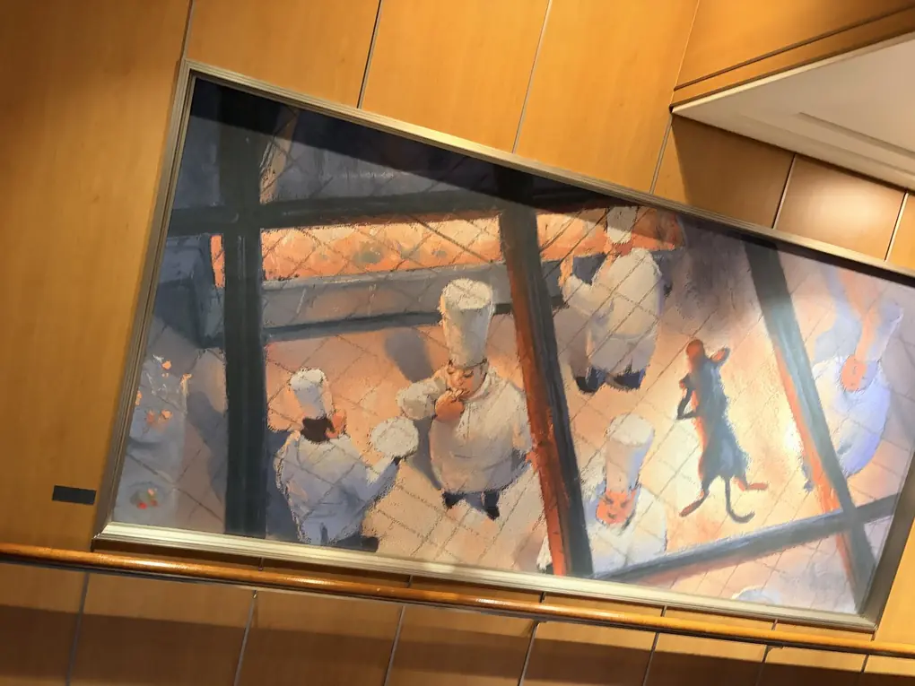 Ratatouille artwork hanging in a stairwell on a Disney cruise ship