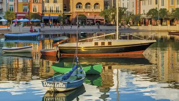 Small boats in the harbor in front of the Mediterranean buildings of Portofino Bay Hotel at Universal Orlando Resort
