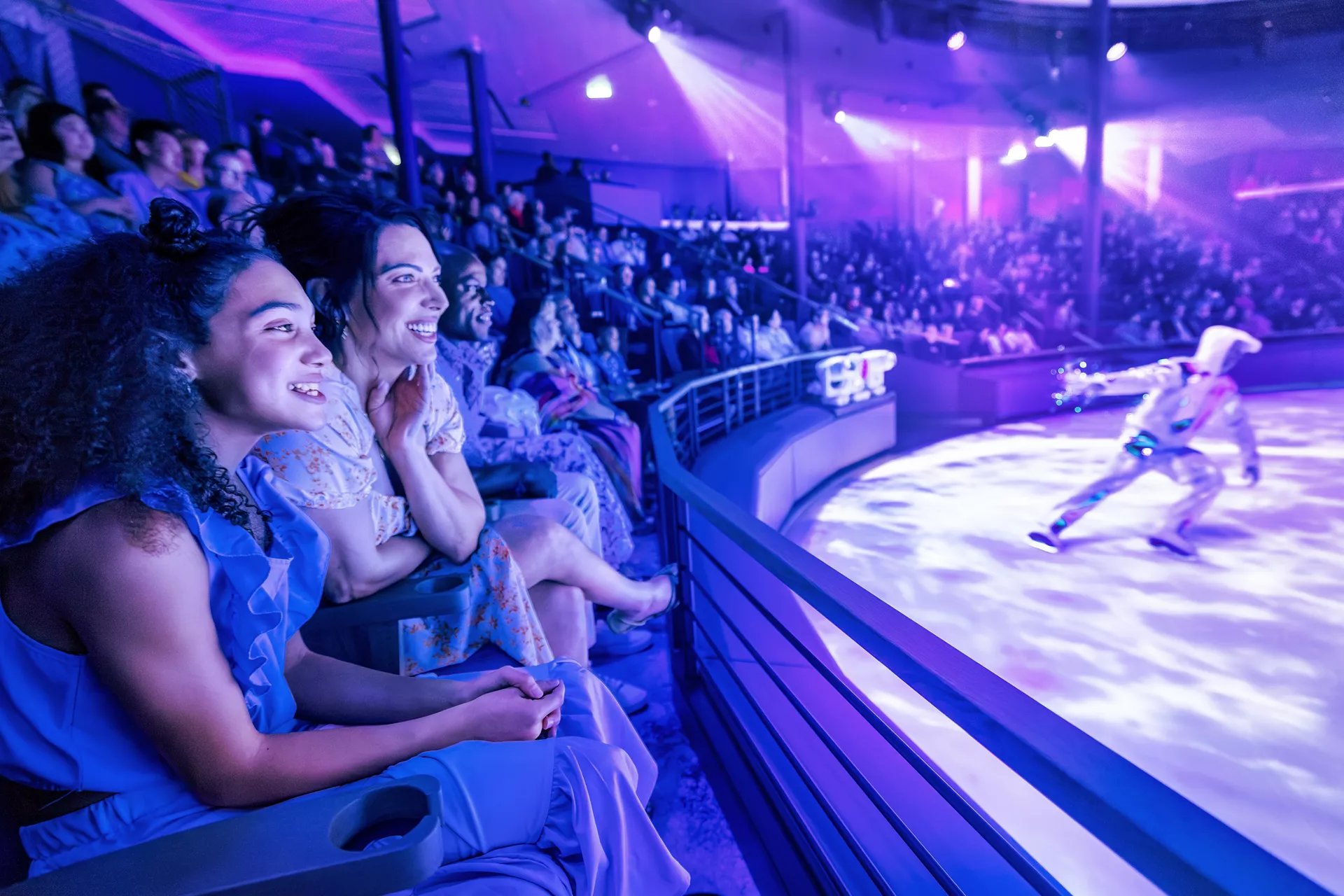 Guests watching an ice skating show from the seats at Absolute Zero on Icon of the Seas