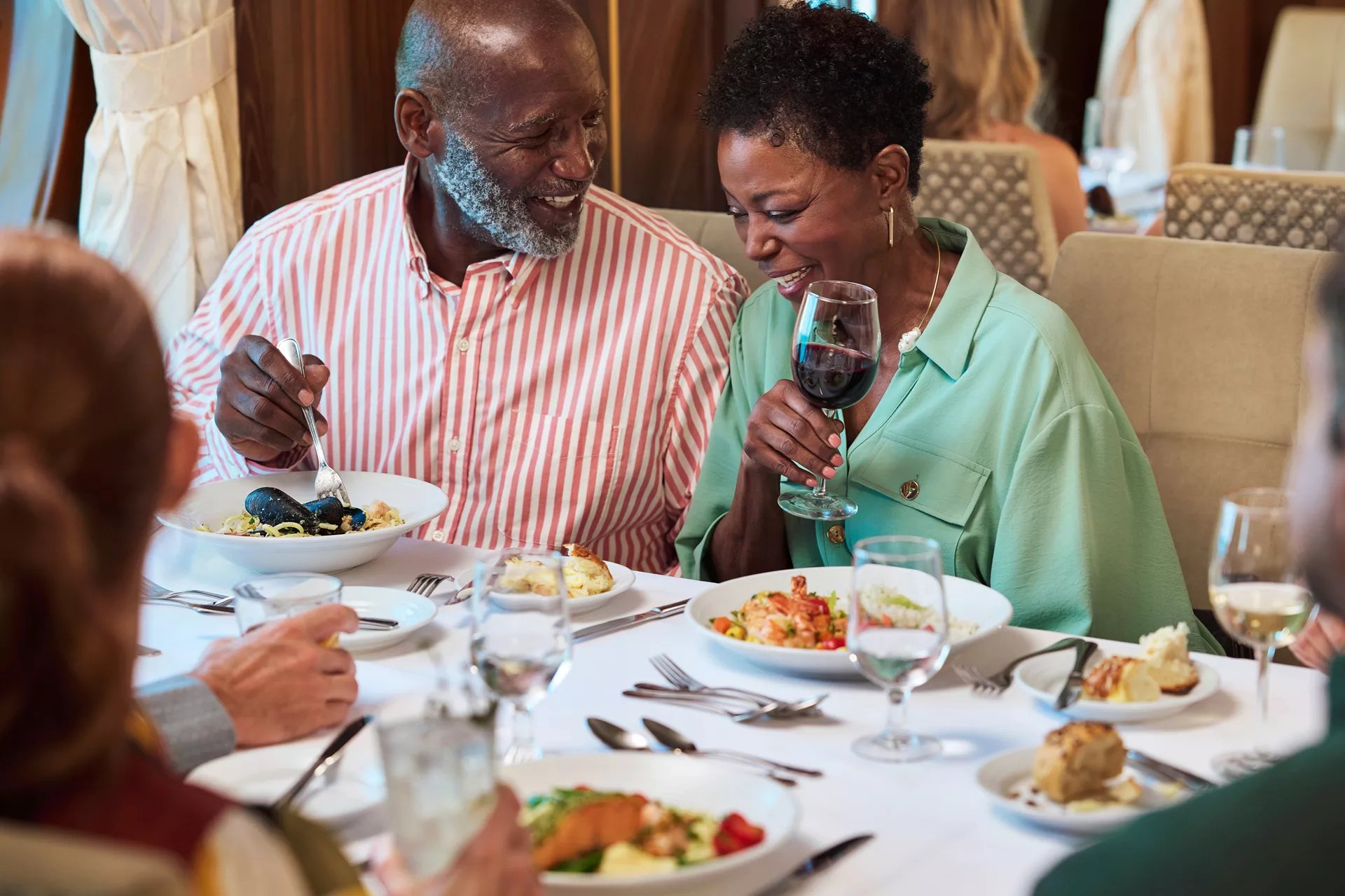 Couple enjoying dinner and wine in a Royal Caribbean main dining room