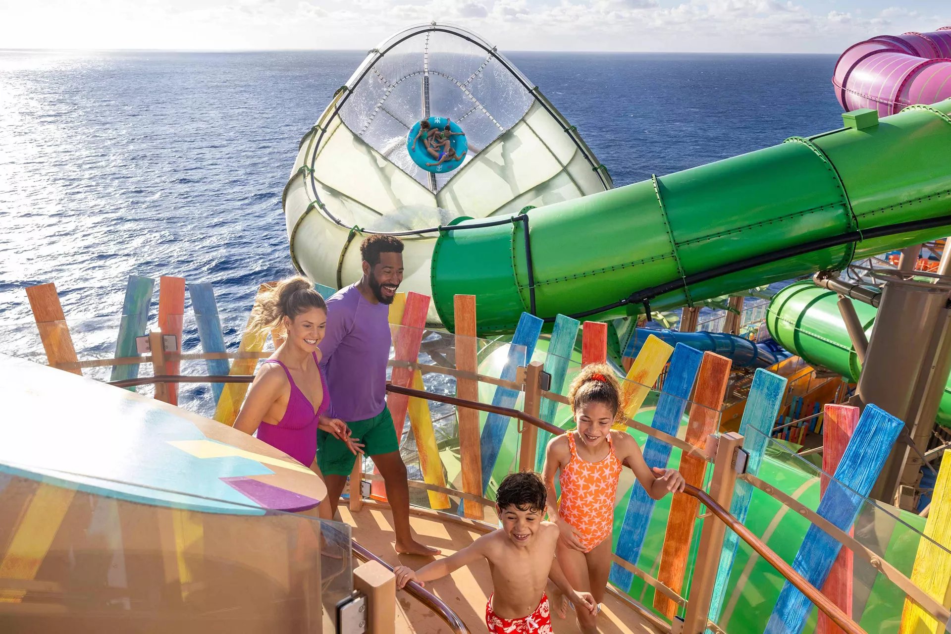 Family climbing the stairs to the Category 6 waterslides on Icon of the Seas
