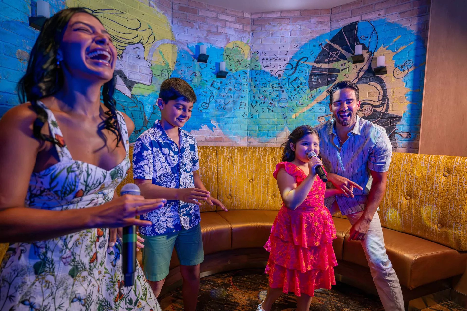 Family singing together at Spotlight Karaoke on Icon of the Seas