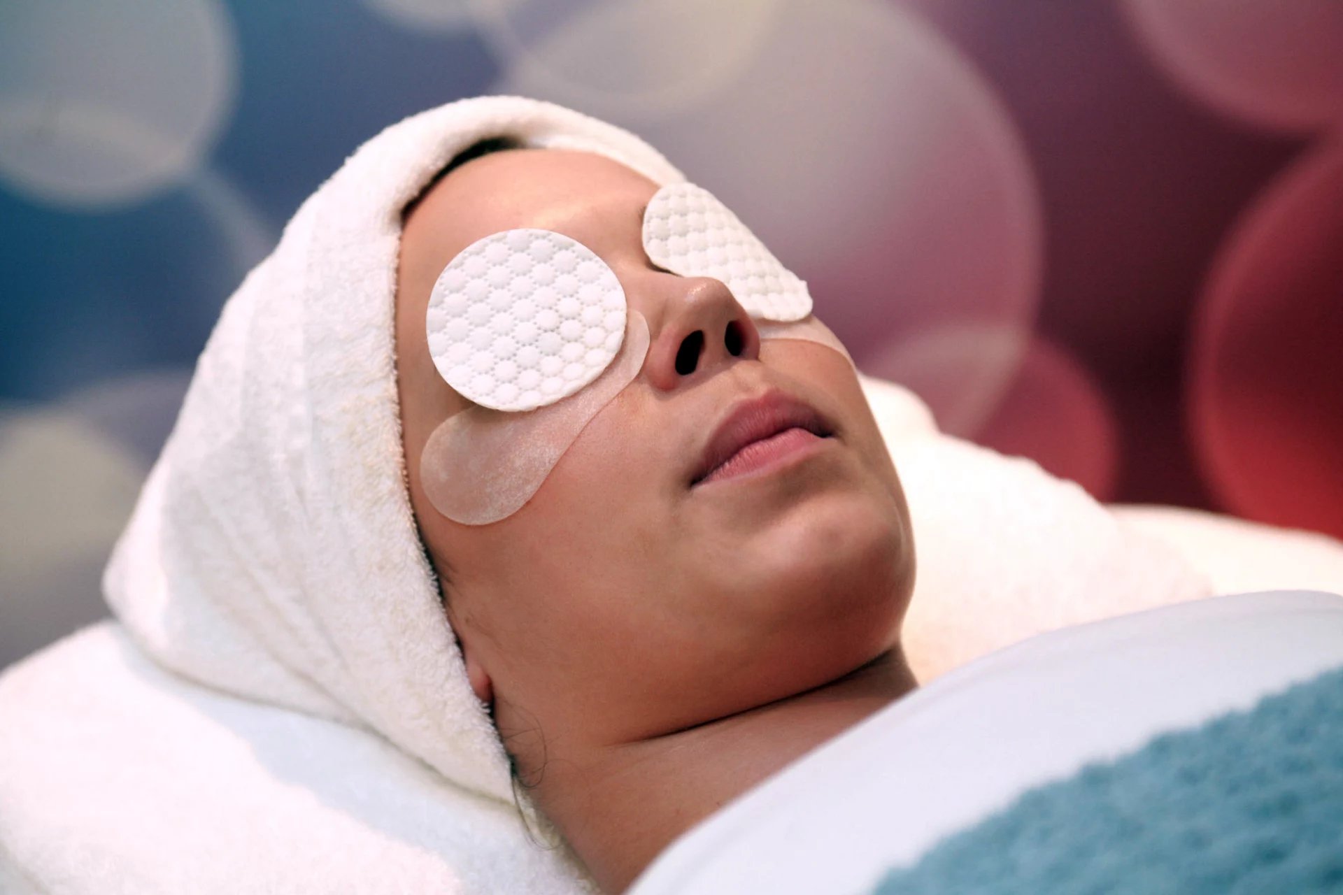 Guest relaxing with eye pads during a facial at a Royal Caribbean Vitality Spa