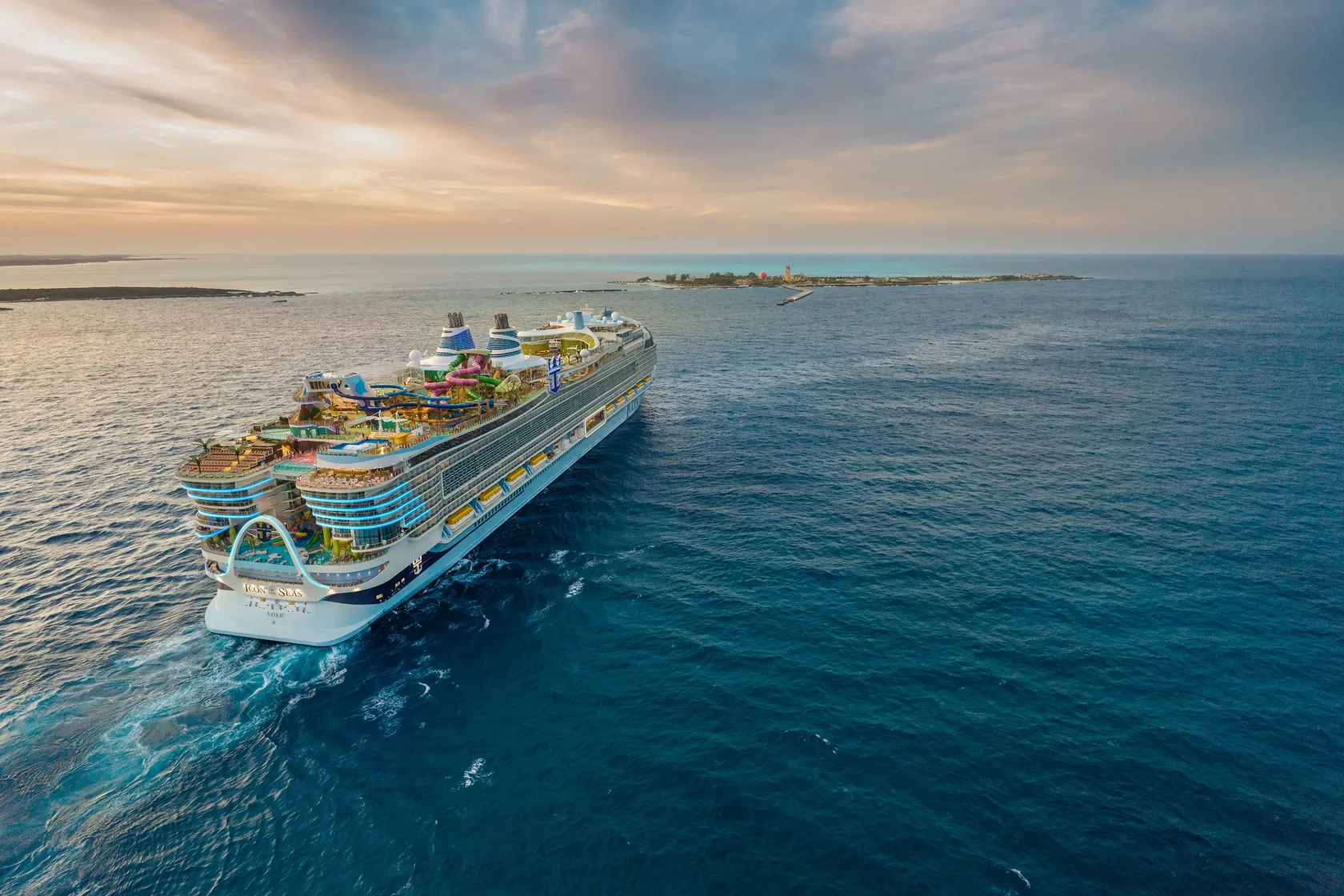 Aerial view of Icon of the Seas sailing on open water at sunset