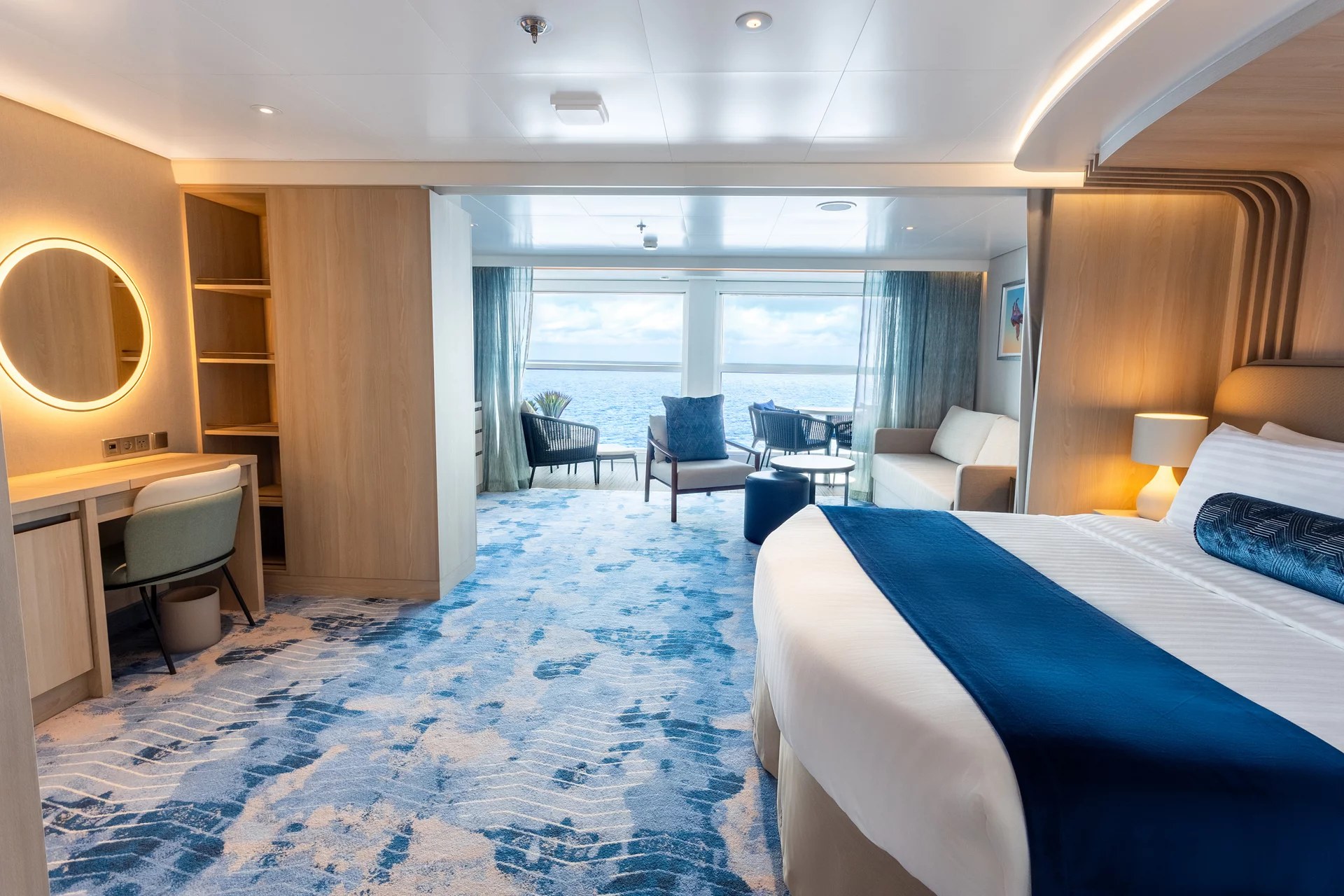 Infinite Grand Suite bedroom and living area on Icon of the Seas
