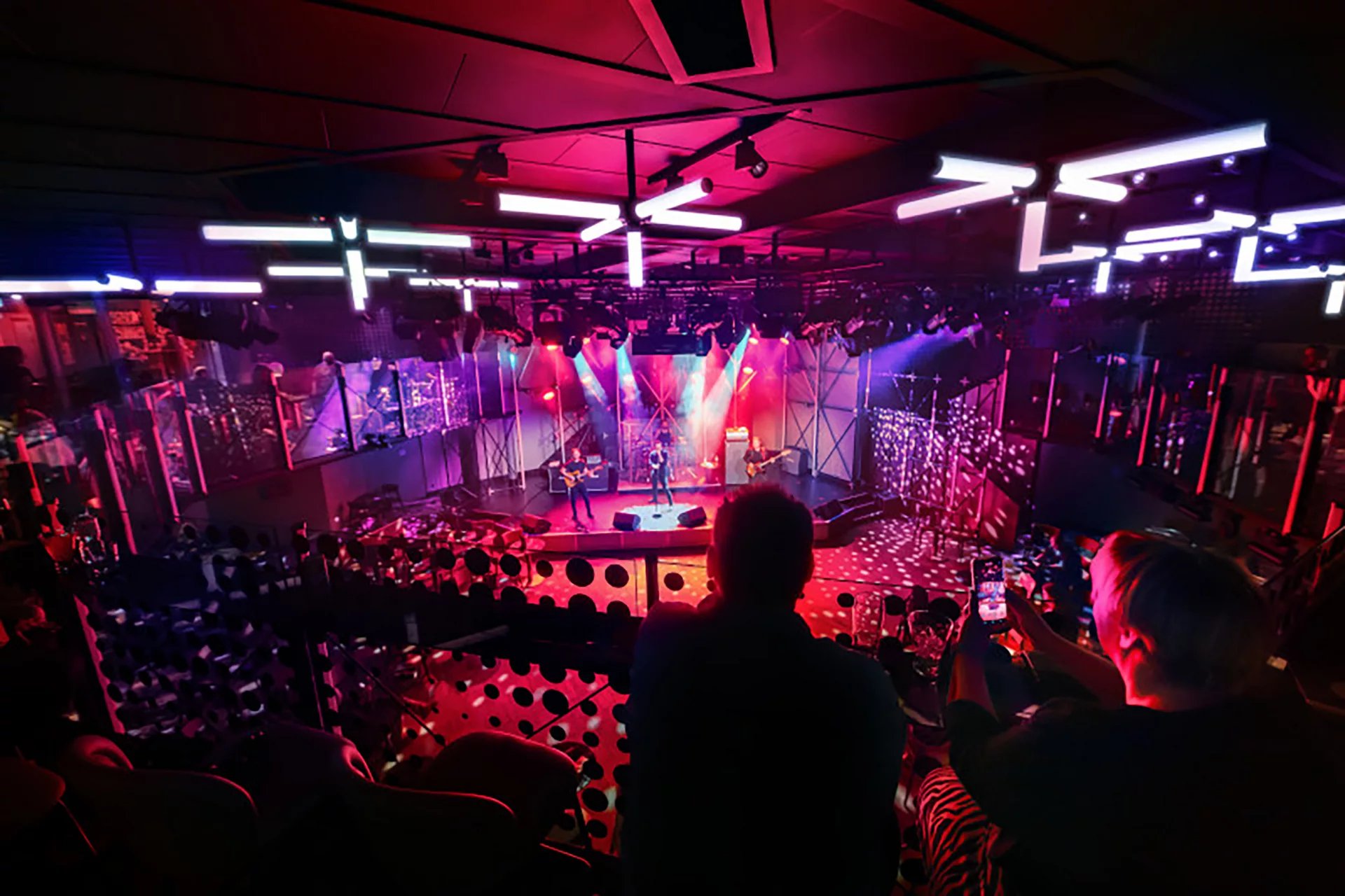 Audience looking down at a live band on stage at Music Hall on Icon of the Seas