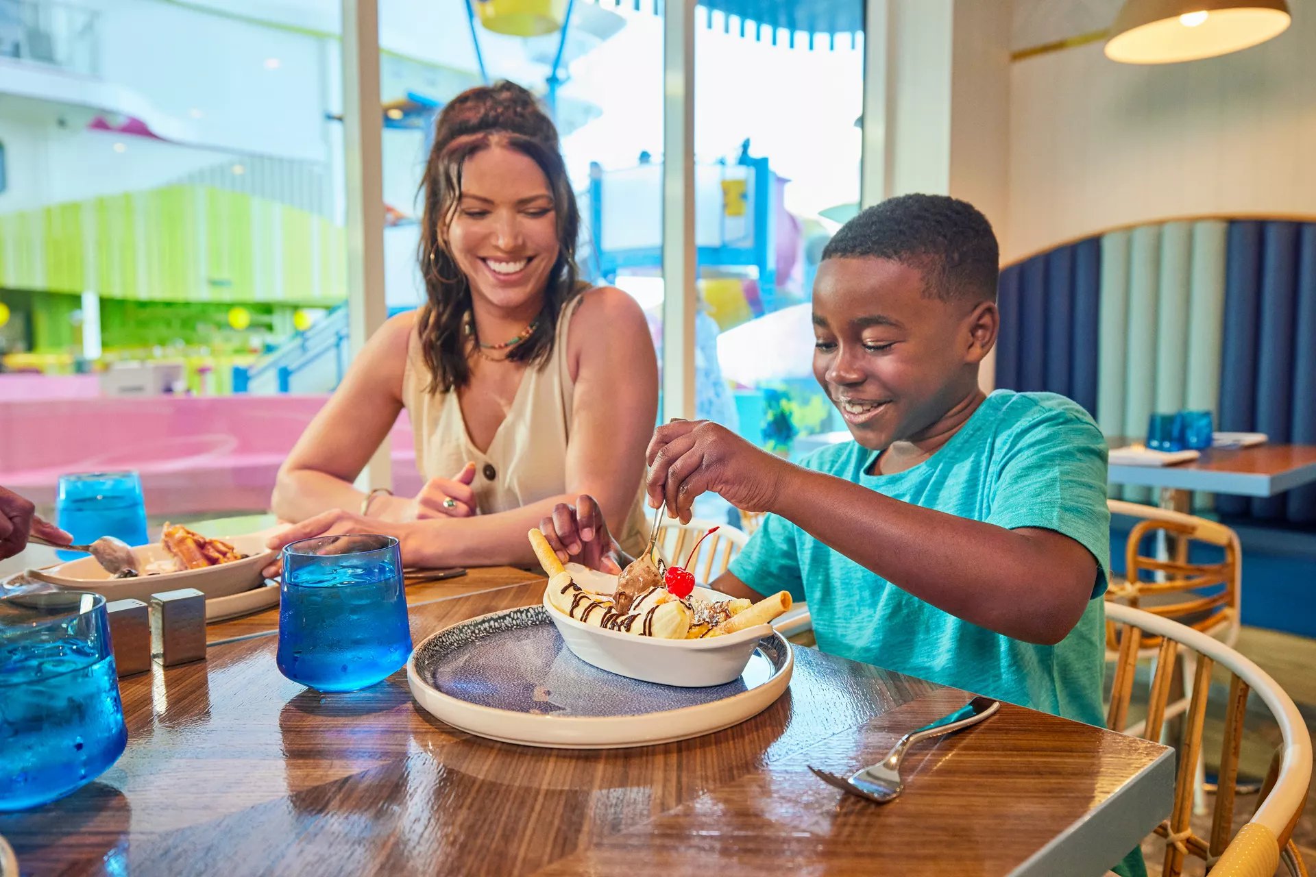Mother and son sharing an ice cream sundae at Pier 7 in Surfside on Icon of the Seas