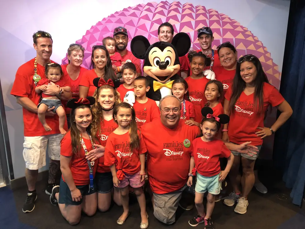 Multigenerational family posing with Mickey Mouse at Walt Disney World
