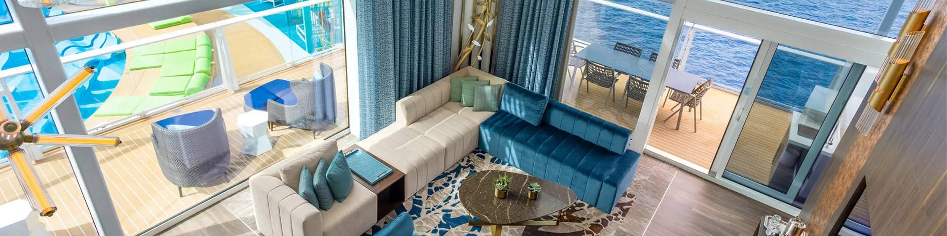 Living room and balcony of the Royal Loft Suite on Icon of the Seas