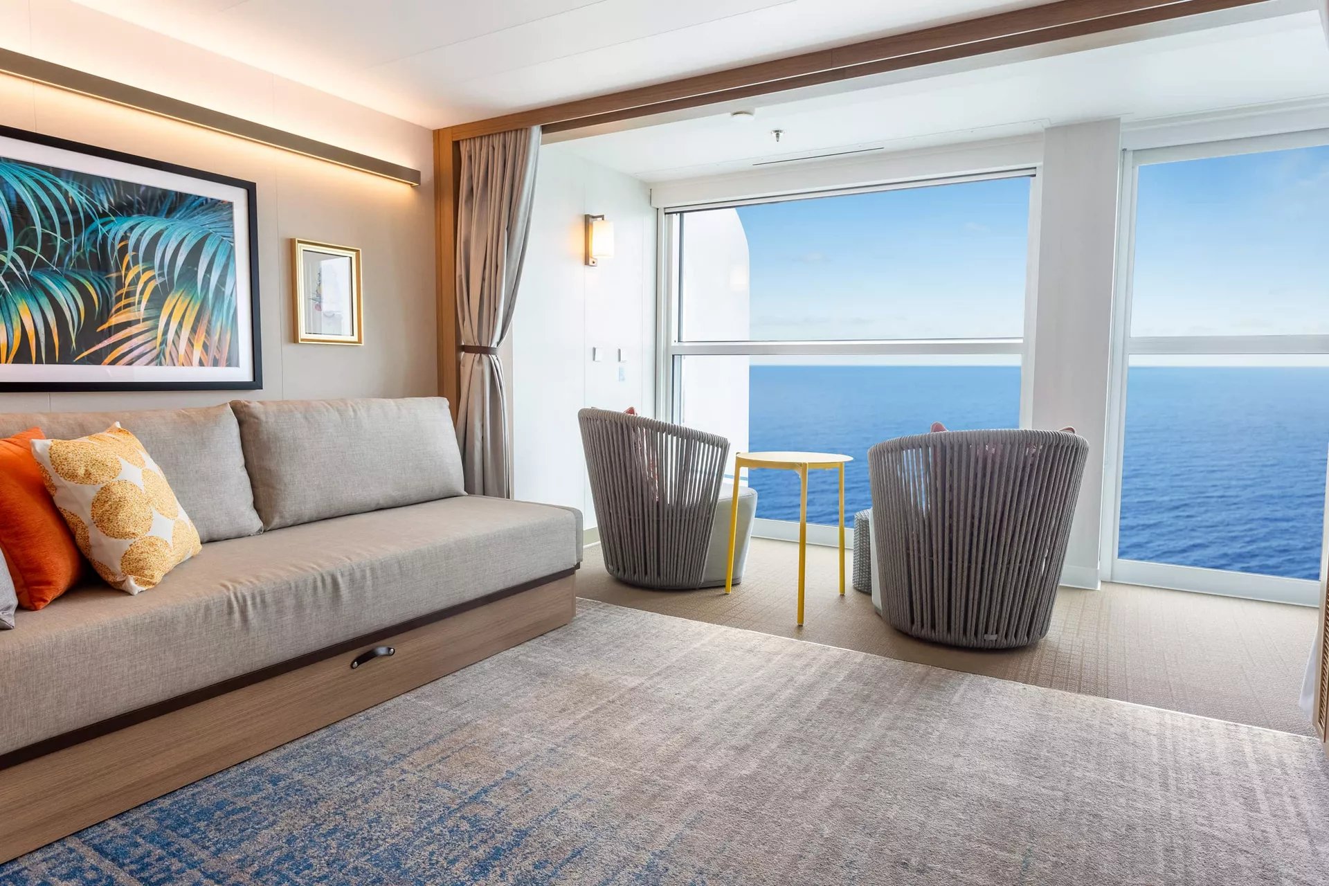Spacious Infinite Ocean View Balcony stateroom with a sofa and ocean view on Icon of the Seas