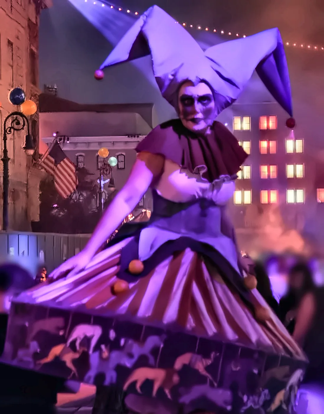 Stilt Walking Jester Scare Actor in New York Area at Halloween Horror Nights - Favorite Grampy Travels - Favorite Grampy Travels A scare actor dressed as a jester on stilts in a purple and red costume on the New York street at Halloween Horror Nights.
