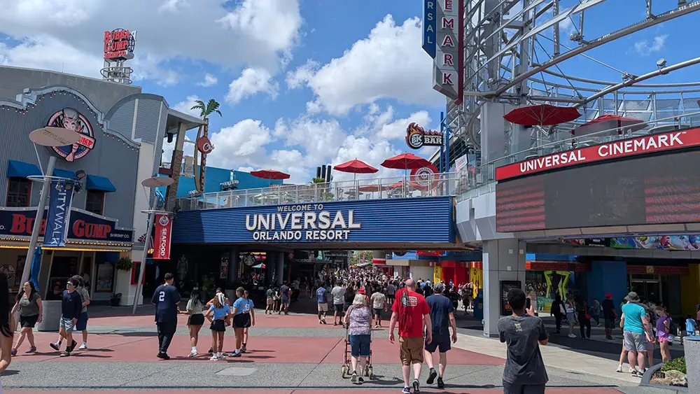 A crowd walks toward the Universal CityWalk Orlando entrance sign. - Favorite Grampy Travels