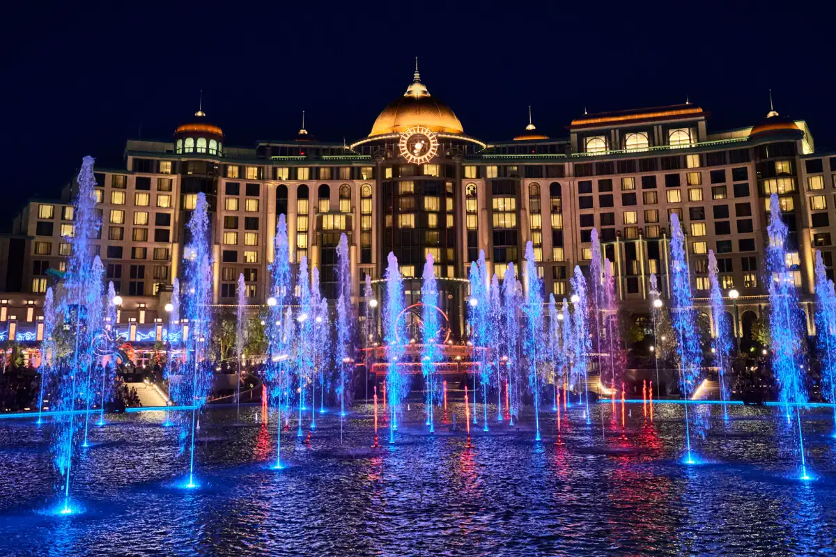 Universal Helios Grand Hotel and the Celestial Park fountains lit up at night