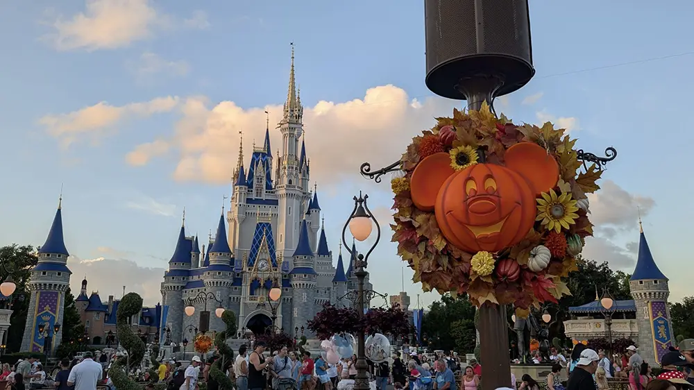 Wdw-magic-kingdom-halloween-decorations-pumpkin-mickey-wreath-in-front-of-castle - Favorite Grampy Travels Cinderella Castle at Magic Kingdom decorated with a Mickey-shaped pumpkin wreath, a perfect sight for your next Disney family guide autumn visit. - Favorite Grampy Travels