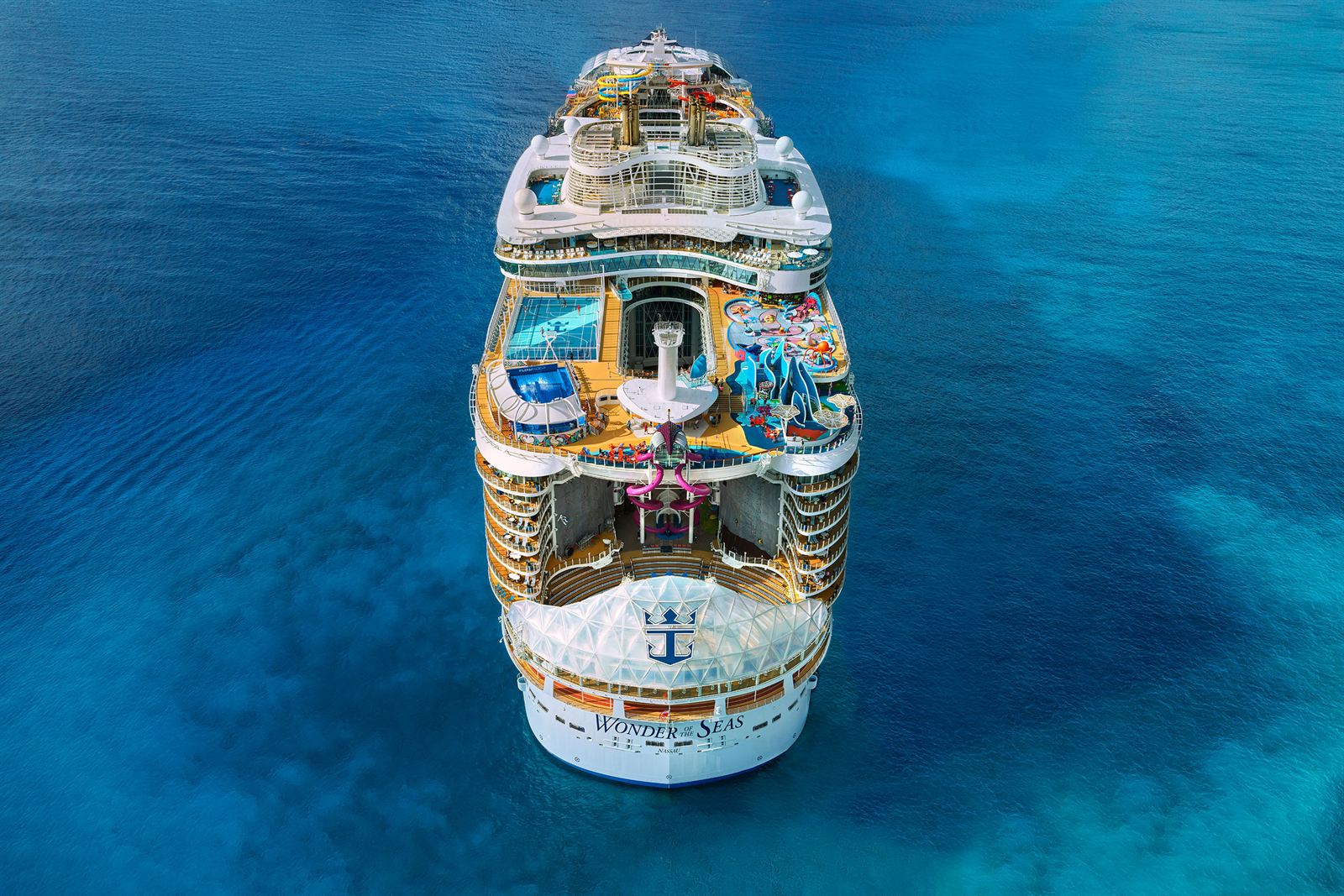 Aerial view of Royal Caribbean's Wonder of the Seas, an Oasis Class ship, sailing on blue water